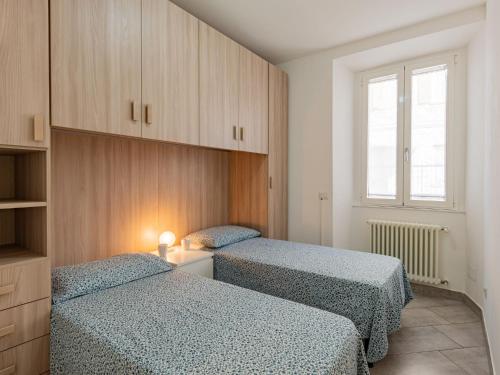 a bedroom with two beds and a window at Apartment Bina by Interhome in Bellano