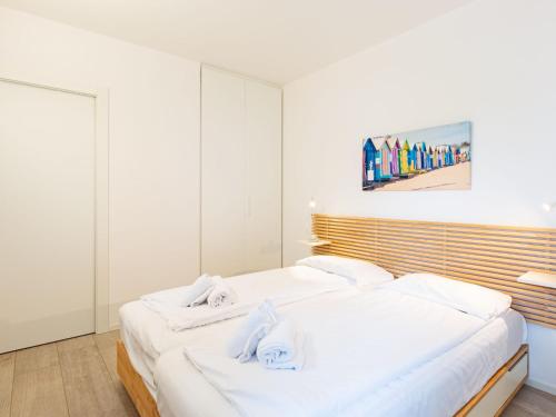 a bedroom with two white beds with towels on them at Apartment Am See by Interhome in Riva del Garda