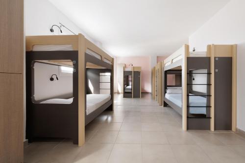 a room with four bunk beds in a room at Local Hostel & Suites in Corfu Town