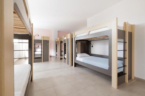 a room with bunk beds and a hallway at Local Hostel & Suites in Corfu Town