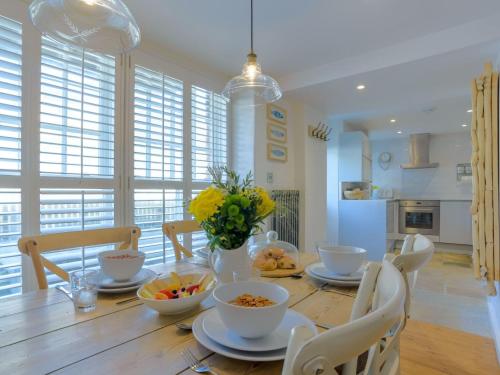 a dining room with a table with bowls of food at Apartment Salty Seadog by Interhome in Treknow