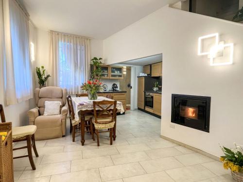 a living room with a table and a fireplace at Apartment Casa Lulú by Interhome in San Lorenzo al Mare
