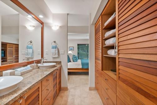 a bathroom with two sinks and a large mirror at Maui Paradise Townhouse in Wailea