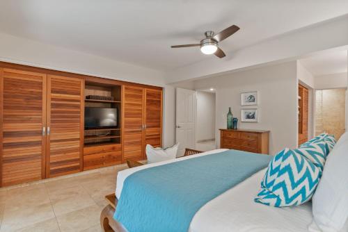 a bedroom with a large bed and a television at Maui Paradise Townhouse in Wailea