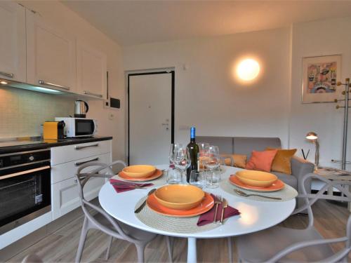 uma cozinha e sala de jantar com uma mesa branca e cadeiras em Apartment Olmo Garden Apartment by Interhome em Morbegno