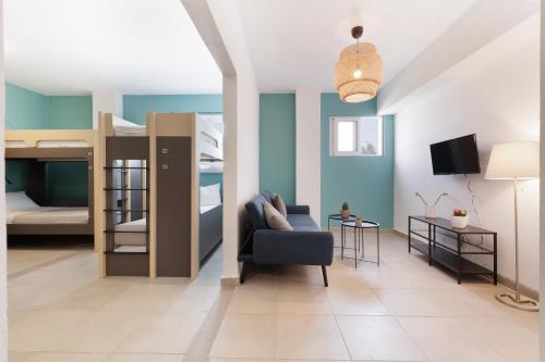 a living room with a couch and bunk beds at Local Hostel & Suites in Corfu Town