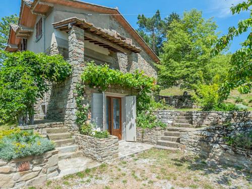 a stone house with stairs leading to a door at Holiday Home Bellavista by Interhome in Cortona