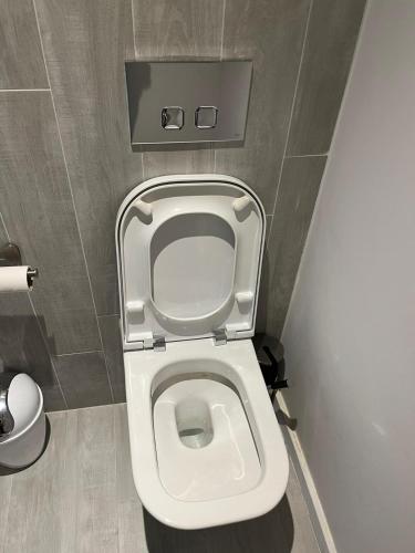- une salle de bains avec des toilettes blanches dans une cabine dans l'établissement A 1 minutes du parc des expositions, à Paris