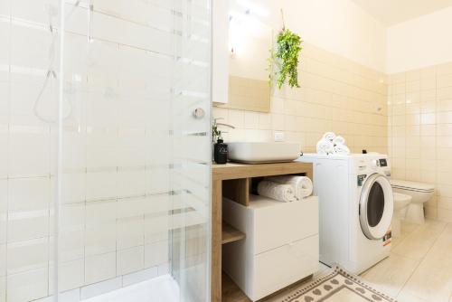 a bathroom with a washing machine and a washer at AnticaValle Intero Appartamento in Verona