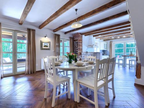 une salle à manger avec une table et des chaises blanches dans l'établissement Villa Feniks by Interhome, à Višnjan