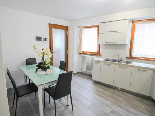 a kitchen with a table and chairs and a sink at Apartment Elsa by Interhome in Dumenza