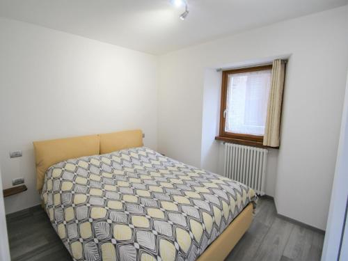 a bedroom with a bed in a room with a window at Apartment Elsa by Interhome in Dumenza