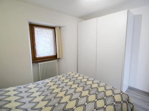 a bedroom with a bed and a window at Apartment Elsa by Interhome in Dumenza