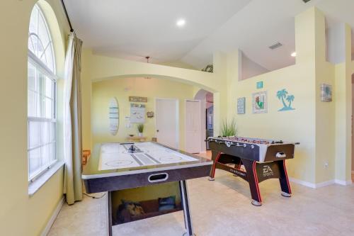 a large room with a ping pong table in it at Jensen Beach Home with Heated Pool! in Jensen Beach