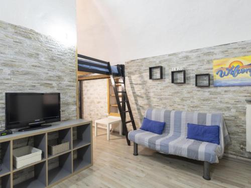 a living room with a tv and a couch at Holiday Home Kicca by Interhome in Sanremo