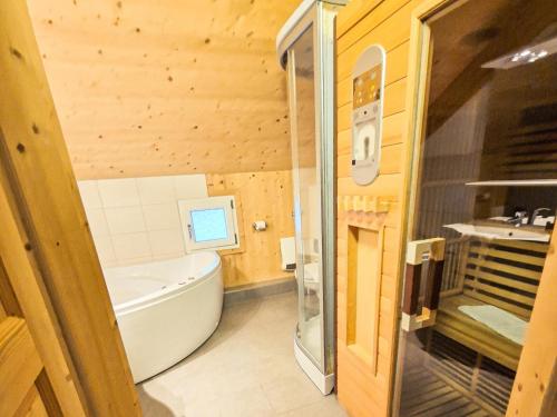 a bathroom with a tub and a sink at Kreischberg 14b in Sankt Lorenzen ob Murau