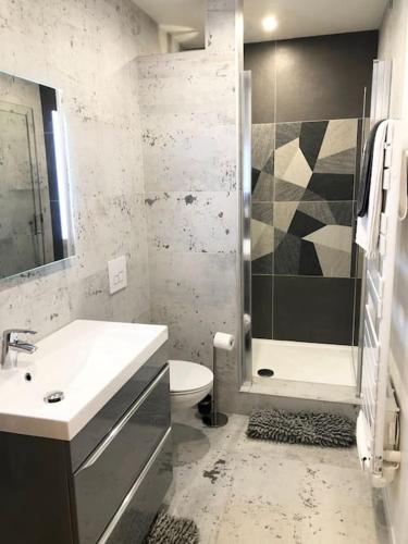 une salle de bain avec un lavabo, des toilettes et une douche dans l'établissement Appartement avec terrasse, à Villemomble