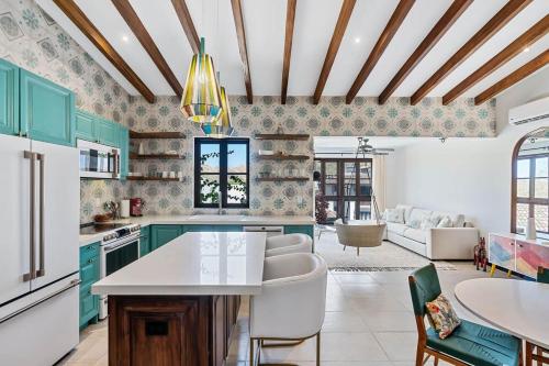 a kitchen with green cabinets and a white counter top at Trendy Condo with Modern Decor, Stunning Ocean Views, and Exclusive Beach Club Access in Playa Danta