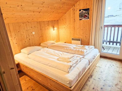 a bedroom with two beds in a wooden wall at Kreischberg 14b in Sankt Lorenzen ob Murau