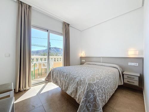 Postel nebo postele na pokoji v ubytování Hotel Noguera El Albir