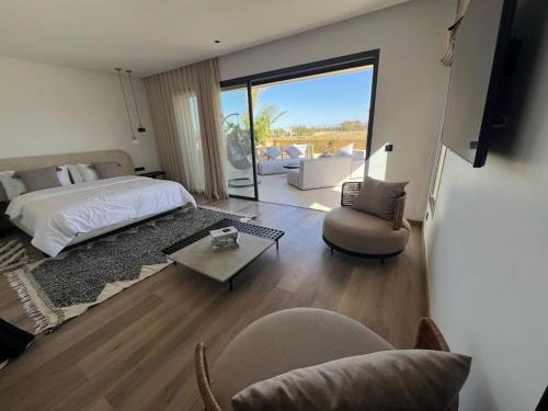 a bedroom with a bed and a living room at villa in Marrakesh