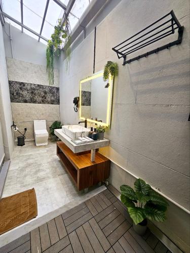 a bathroom with a sink and a mirror at Nyast Valley Resort by Autumleafs, Goa in Arpora