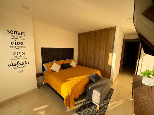 a bedroom with a bed and a sign on the wall at Departamento a pie de playa en Camino al Mar in Mazatlán