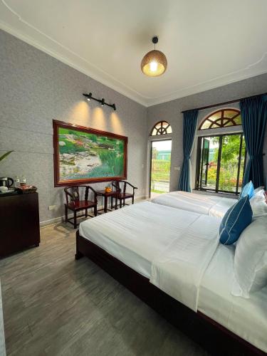 a bedroom with a large bed and a large window at Hoa Lu Garden Resort in Ninh Binh