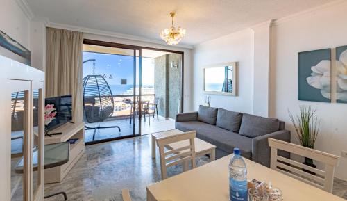 un soggiorno con un divano e un tavolo di Sunset view 3 a Puerto de Santiago