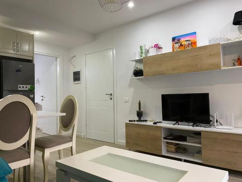 a living room with a flat screen tv on a wall at gabriela apartments in Sarandë