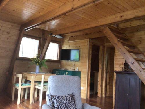 a room with a table and a tv in a cabin at Chalet Natura Sport&Relax in Cavaliere