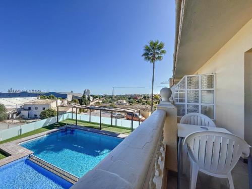 a balcony with a swimming pool and a table and chairs at Hotel Noguera El Albir in Albir