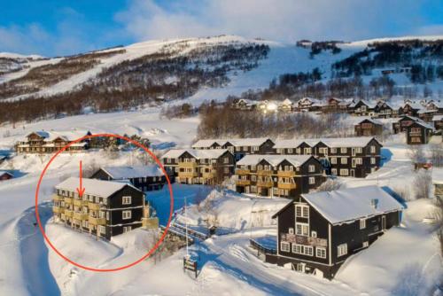 una vista aérea de un complejo en la nieve en Flott leilighet med ski in ski out, utsikt og balkong en Oppdal