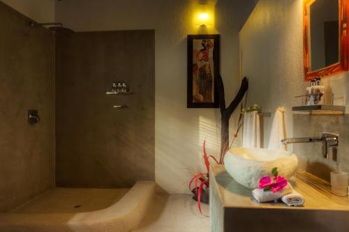 a bathroom with a sink and a bath tub at Naledi Lodges in Balule Game Reserve