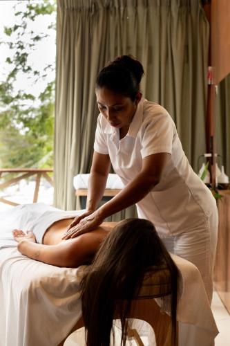 a woman sitting on a bed with a patient at Bufo Alvarius in Tulum