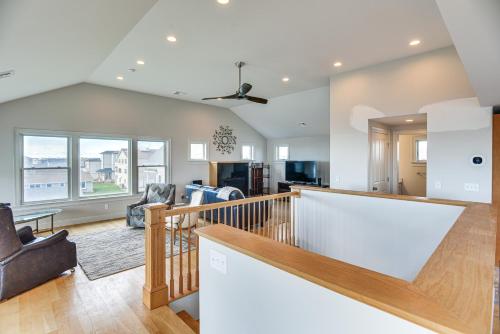 a living room with a staircase and a living room at Narragansett Home with Scenic Views Walk to Beach! in Narragansett