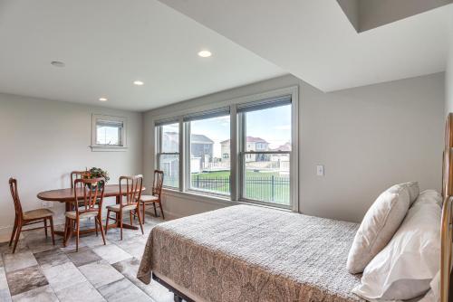 a bedroom with a bed and a table and chairs at Narragansett Home with Scenic Views Walk to Beach! in Narragansett