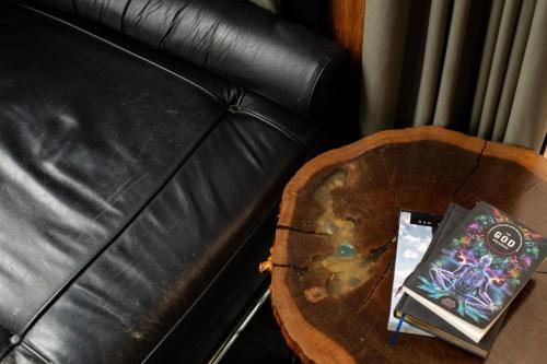 a table with two books on it next to a couch at Bufo Alvarius in Tulum