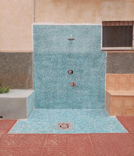 a blue tiled shower with a ball in it at Lookatbeach in Oropesa del Mar