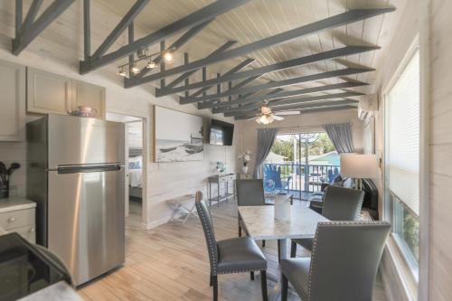 a kitchen and dining room with a table and a refrigerator at Lantana Suite in Captiva
