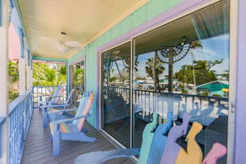 a porch with blue chairs and a swimming pool at Lantana Suite in Captiva