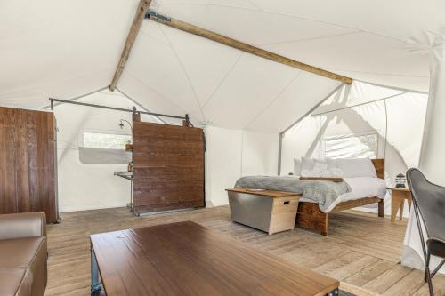 a bedroom with a bed in a tent at Under Canvas Yosemite in Groveland