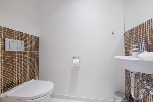 a bathroom with a toilet and a sink at RAFAEL KAISER - Premium Apartments City Centre - Contactless Check-In in Vienna