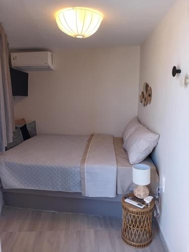 a bedroom with a bed and a lamp on a table at Central House in Plaka in Athens