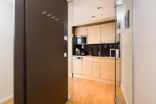 a glass door leading into a kitchen with appliances at RAFAEL KAISER - Premium Apartments City Centre - Contactless Check-In in Vienna