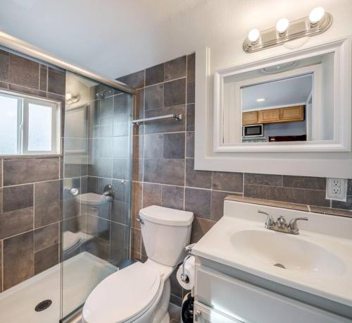 a bathroom with a toilet and a sink and a shower at Adorable Cottage near Scenic Waterfront Park in Everett