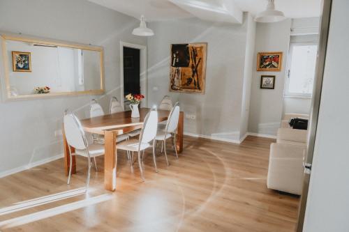 a dining room with a table and chairs at Urban Hotel in Tirana