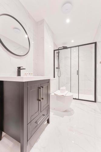 a white bathroom with a sink and a toilet at Lovely 2 Bed Apartment in Burton-on-Trent in Burton upon Trent
