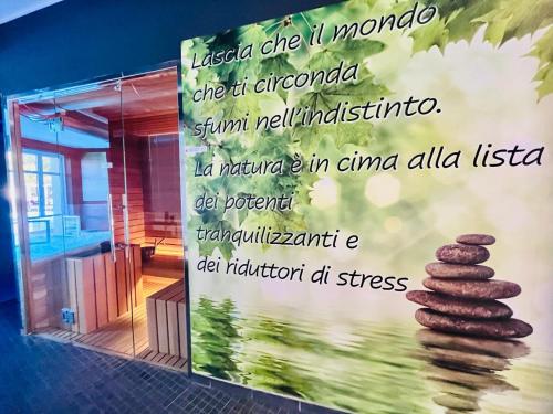 a sign in a room with a stack of cookies at Villa Nonna Cicci Boutique Hotel - SPA in Cisterna dʼAsti