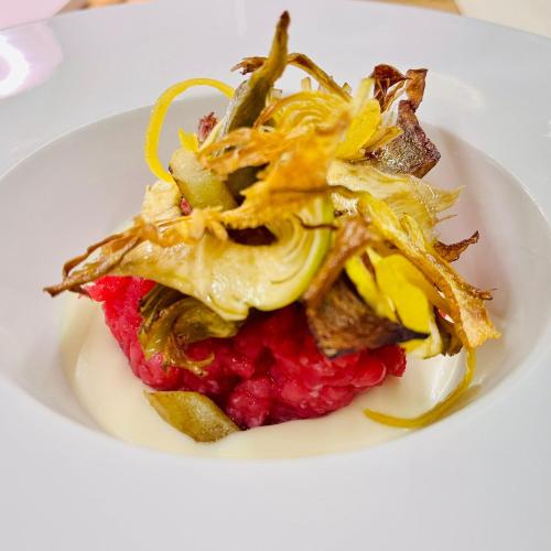 a plate of food on a white plate at Villa Nonna Cicci Boutique Hotel - SPA in Cisterna dʼAsti
